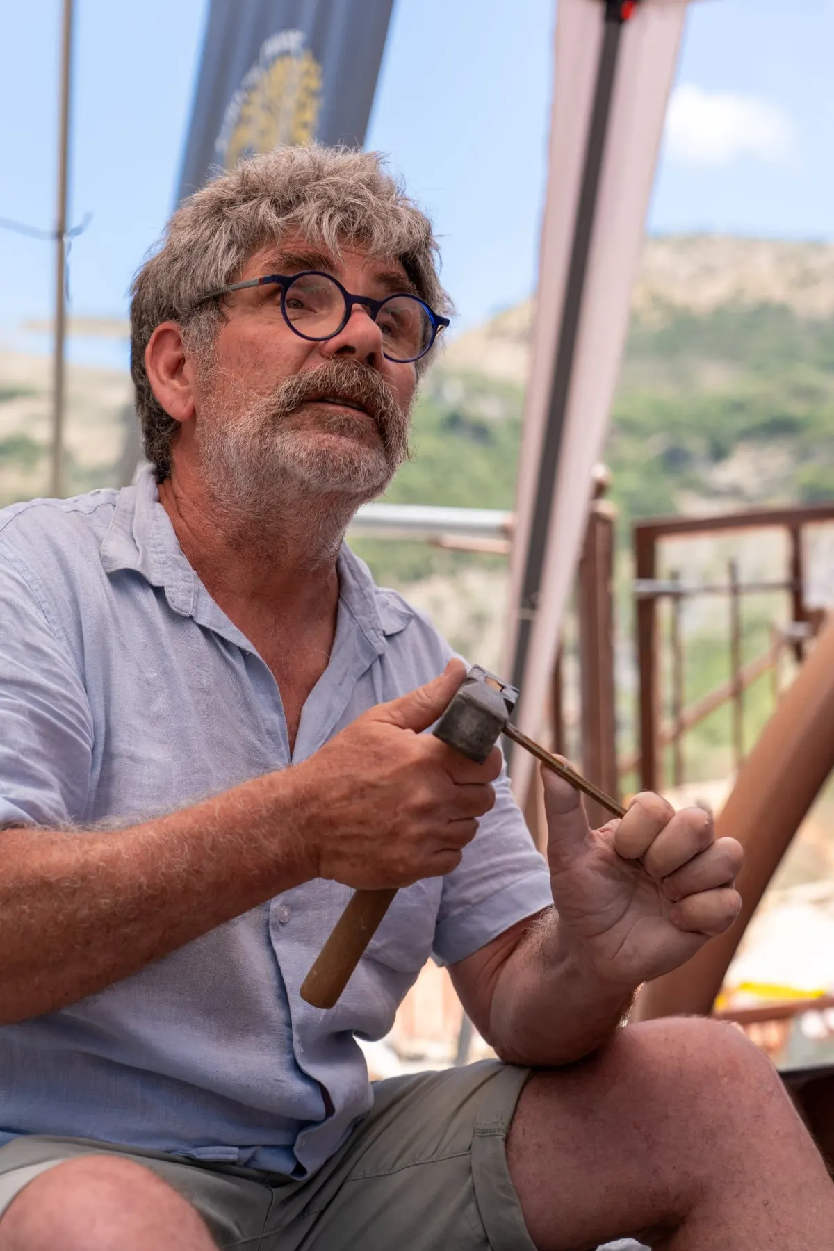 A master mason at work with hammer and chisel
